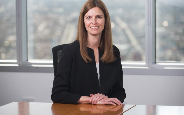 Chairperson and commissioner Kate Symons sitting behind a desk.