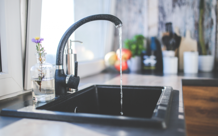 A kitchen tap running water.